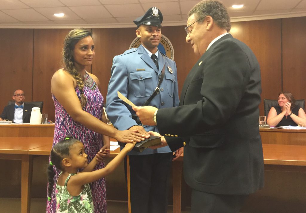 Mayor David Maffei swears in Police Officer Steve Austin who is joined by his wife and one of his two daughters.