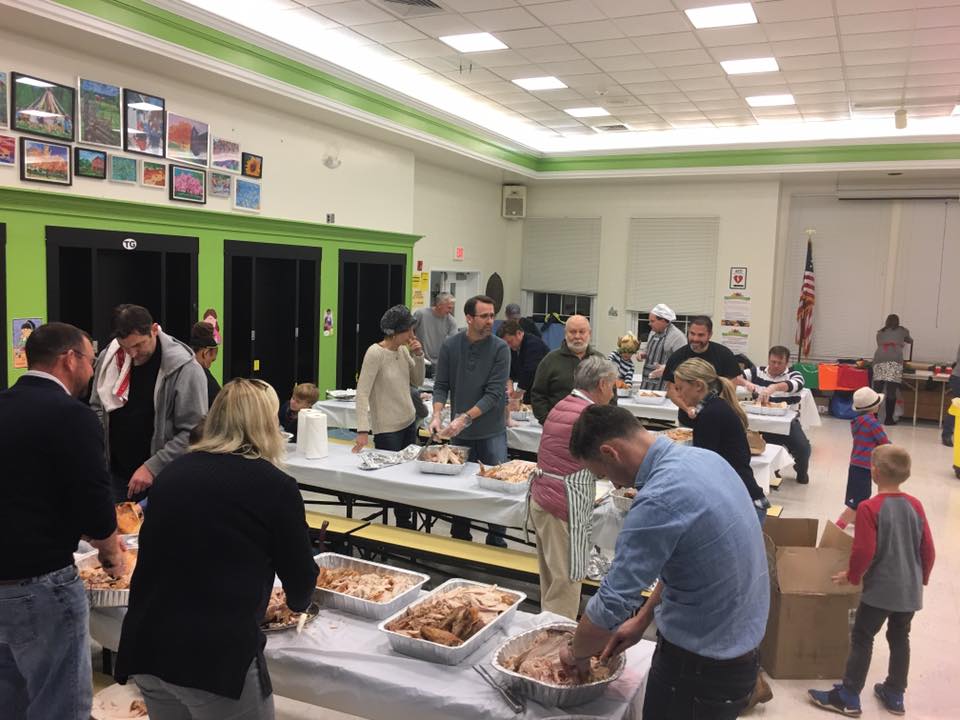 Caption (2): Parents and students came together in the Toll Gate cafeteria Tuesday evening to carve and package 60 turkeys as part of the school’s effort to prepare Thanksgiving dinner for the Trenton Area Soup Kitchen. 